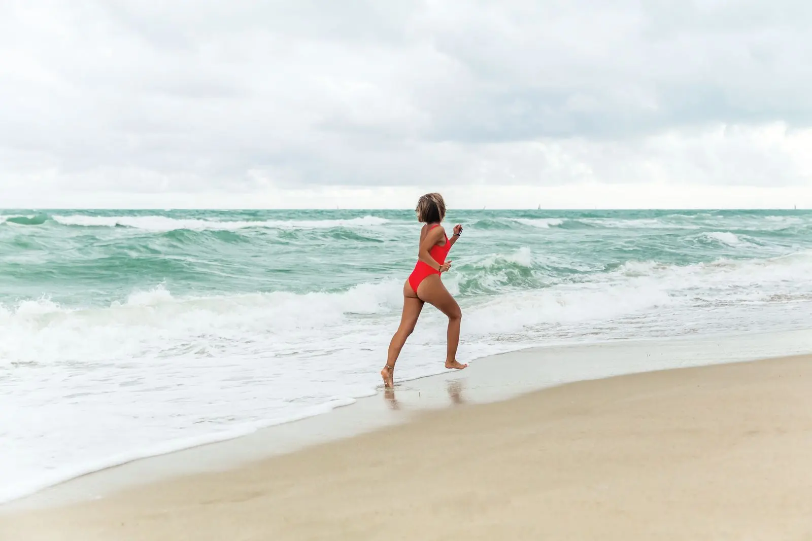 Woman jogging by the ocean