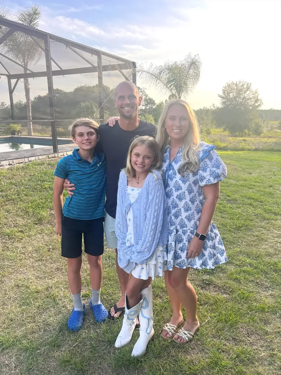 The Stevenson family of four in the backyard by the pool at sunset